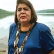 wilma mankiller standing at lake front wearing blue