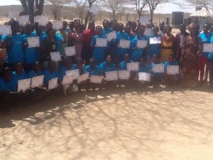 girls in front of school dressed in blue uniforms in kenya 