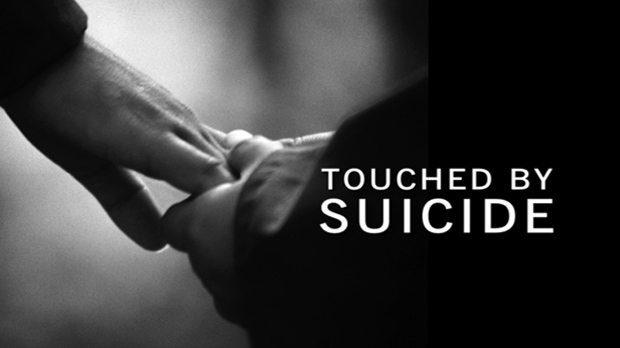 little hand holding bigger hand in black and white photo with text reading Touched by Suicide