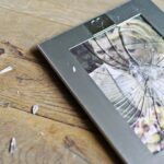 wedding picture in frame with smashed glass broken to pieces symbolizing divorce
