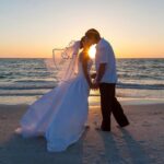 wedding bride and groom kissing on beach