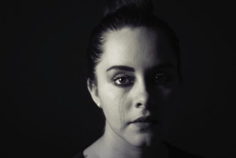 black and white  photo of woman crying showing domestic violence