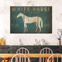 vintage canvas of white horse sitting on wall behind dining table with white woodnen chairs
