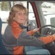 blonde woman driving a tractor trailer