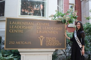 tara teng standing in front of university plaque