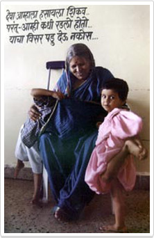 sindhutai sitting in blue sari holding little girl dressed in pink 