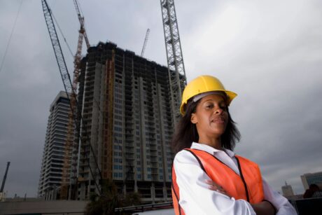 woman wearing yellow hard hat as construction manager on site