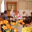 seniors gathered in activity room sitting in chairs