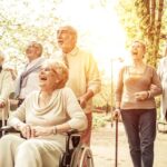 seniors in group laughing with one lady in wheel chair