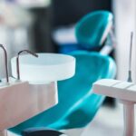 dental chair with rinsing sink and dental tools